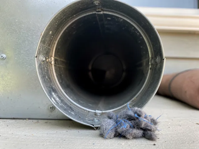 Lennox Dryer Vent Cleaning technician using specialized equipment to clear severe dryer vent blockage in Lennox
